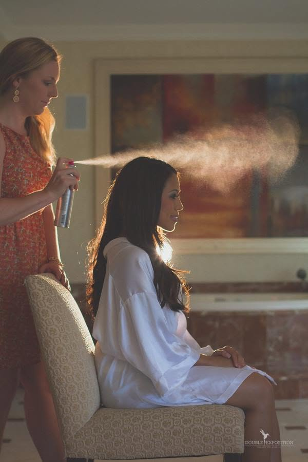 Bride preparing in warm window light